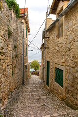 Wall Mural - A residential street in the historic coastal village of Sutivan, Brac Island, Croatia