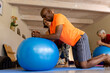 © Wavebreak Media - Focused diverse seniors using exercise balls in pilates class with female coach