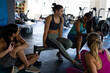 © Wavebreak Media - Multiracial young female friends talking while relaxing in health club after workout