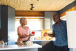 © Wavebreak Media - Happy senior african american couple unpacking groceries in kitchen