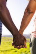 © Wavebreak Media - Holding hands of senior african american couple in sunny nature