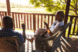© Wavebreak Media - Happy senior african american couple drinking wine on sunny terrace