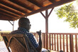 © Wavebreak Media - Senior african american man drinking wine on sunny terrace