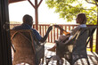 © Wavebreak Media - Happy senior african american couple drinking wine on sunny terrace
