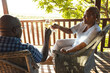 © Wavebreak Media - Happy senior african american couple drinking wine on sunny terrace
