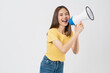 © sitthiphong - Beautiful Asian woman holding megaphone and shout on white background.