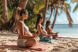 Group of women doing yoga on a beach
