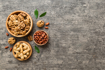 Wall Mural - Walnut kernel halves, in a wooden bowl. Close-up, from above on colored background. Healthy eating Walnut concept. Super foods with copy space