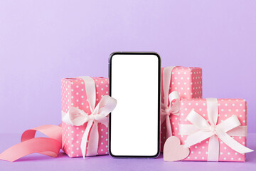 Wall Mural - mobile phone with blank screen on colored background with hearts, calendar and gift box, valentine day concept perspertive view flat lay