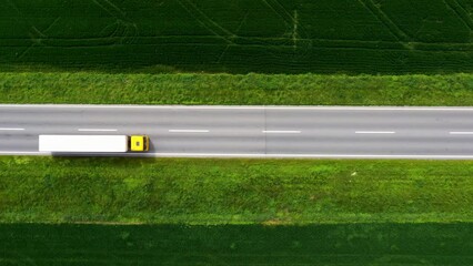 Wall Mural - Traffic on country road from drone pov, aerial shot of cars and truck on highway