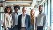 © Sasint - Portrait of successful group of business people at modern office looking at camera. Portrait of happy businessmen and satisfied businesswomen standing as a team. Multiethnic group of people smiling.