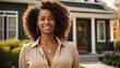 African American female real estate agent stands proudly outside a modern home
