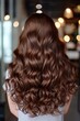 © Bargais - Back view of a girl with beautiful wavy brown hair.