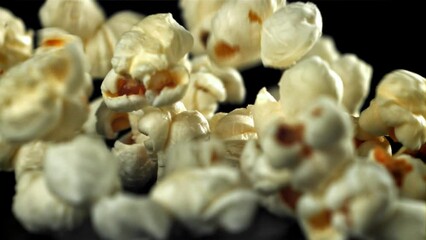 Poster - Popcorn falls on the table. On a black background. Filmed on a high-speed camera at 1000 fps. High quality FullHD footage