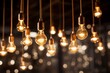 Festive glowing lamp bulbs on blurred sparkling background conveying sense of celebration