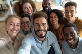 Fototapeta Sport - Coworkers in the office, exchanging smiles and laughter during team-building sessions, with a focus on a group selfie that reflects their collaborative spirit