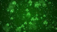 Lucky Shamrocks, Shiny Stars And Glowing Glittering Particles On A Dark Green Gradient Background. This Saint Patrick's Day Celebration Party Background Animation Is Full HD And A Seamless Loop.