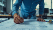 © The Stock Photo Girl - close up of architects working on blueprints