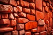 Orange stone wall. Bright brown rock texture. Red faceted stone wall background for design. Modern architecture, granite structure. Red brick wall grunge background. Cement construction material 