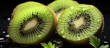 Kiwi Fruit Slices On Black Background