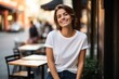 © Nerea - Portrait of a beautiful young woman smiling at the camera in a cafe