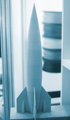 art object model rocket printed on 3d printer. rocket toy created by 3d printing from molten plastic