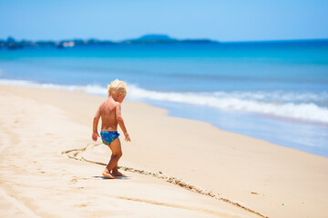 Wall Mural - Kids playing on beach. Children play at sea.