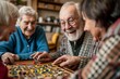© Maria - A senior man with a white beard and glasses joyfully plays a board game with elderly companions in a bright, homely living room, exuding warmth and happiness.