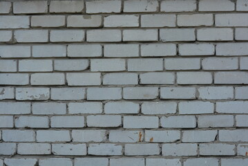 Wall Mural - Unusual construction background, white bricks smeared with gray cement, not professional and uneven. The Soviet wall is made of light, white brick.