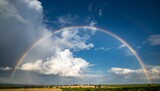 Fototapeta Tęcza - white clouds in the blue sky and colourful rainbow