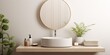 Minimalist Scandinavian bathroom with a white sink, mirror, potted plant, and cozy ambiance in a domestic apartment.