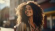 © Ivy - young african american woman smiling in the street with her long hair, in the style of explosive pigmentation