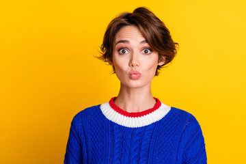 Wall Mural - Photo portrait of attractive young woman look camera pouted lips wear trendy blue knitwear clothes isolated on yellow color background