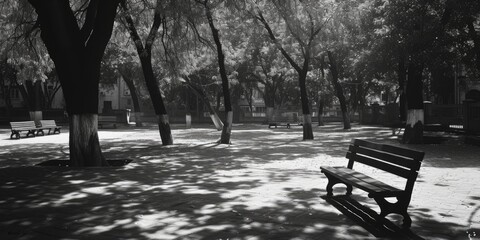 Poster - A black and white photo of a park bench. Ideal for adding a touch of nostalgia or serenity to any project