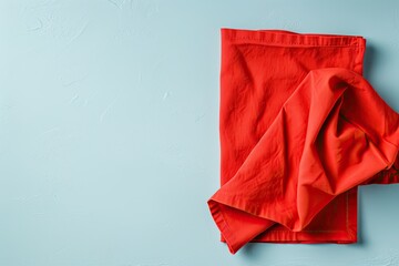 Poster - Top view of red empty kitchen napkin isolated on table background Folded cloth for mockup with space for text Simple and minimalist flat lay style