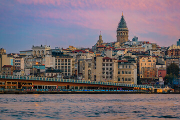 Wall Mural - Sunrise cityscape of the Karakoy area across Bosphorus Strait by Galata Bridge with the Galata Tower at the golden hour of sunrise in Istanbul, Turkey