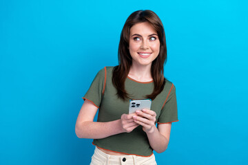 Canvas Print - Photo of creative nice girl hold smart phone look interested empty space isolated on blue color background