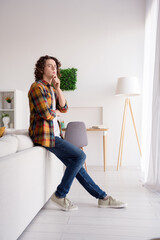 Poster - Vertical full length photo of thoughtful unsure guy dressed checkered shirt hand arm chin thinking indoors house home room