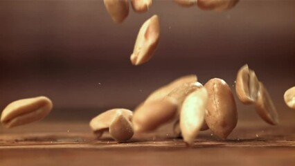 Canvas Print - Peanuts fall on the table. Filmed on a high-speed camera at 1000 fps. High quality FullHD footage