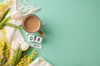 Floral flourish: a glam gathering to celebrate International Women's Day. Top view photo of cube calendar, hearts, hot coffee, scarf, tulips, mimosa on turquoise background with space for greetings