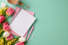 Blossoms Of Empowerment: A Glamorous Gala For Women's Day Triumphs. Top View Photo Of Notebooks, Hearts, Hot Cocoa, Pen, Flowers On Turquoise Background With Space For Greeting Message