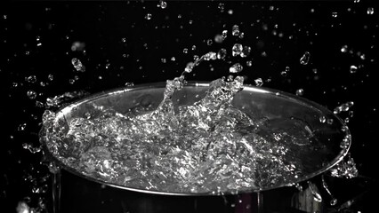 Sticker - Splashing water in a saucepan on a black background. Filmed on a high-speed camera at 1000 fps. High quality FullHD footage