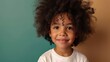 afro american smiling boy with curly hair stay in white long sleeve