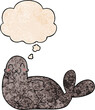 cartoon seal and thought bubble in grunge texture pattern style
