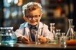 A little boy in special clothes in a laboratory conducts experiments with liquids in glass flasks. The profession of a chemical scientist