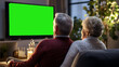 back, rear view of Senior couple watching television show. mature retired pair watching TV. grandfather, grandmother.  grey haired aged senior watching TV in living room. green mock up. Generative ai