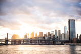 Fototapeta  - View of Lower Manhattan skyline and Manhattan Bridge seen from the East River in New York City, United States.