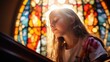 © Svetlana - baby's first communion in church. a child prays near a stained glass window. faith hope. girl folded his hands in prayer