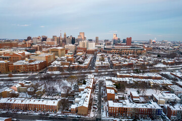 Wall Mural - Drone View of Baltimore City Skyline with Snow Covered Roofs at Sunset with Blue Skies