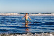 © AlexPhotoStock - Kid bathing in the sea. Boy having fun in the ocean waves at sunset on a sunny summer vacation day. Child having fun outdoors.